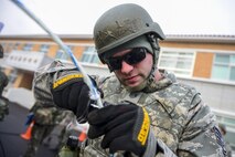 U.S. Air Force Staff Sgt. Adam Nichols, 51st Communications Squadron cable and antenna technician, cuts open a cable during a joint communications exercise at Gwanju Air Base, Republic of Korea, Dec. 13, 2016. Several 51st CS Airmen worked alongside their ROKAF counterparts from Gwanju during the exercise, which focused on the ability to quickly restore communications in the event of an attack. (U.S. Air Force photo by Senior Airman Victor J. Caputo)