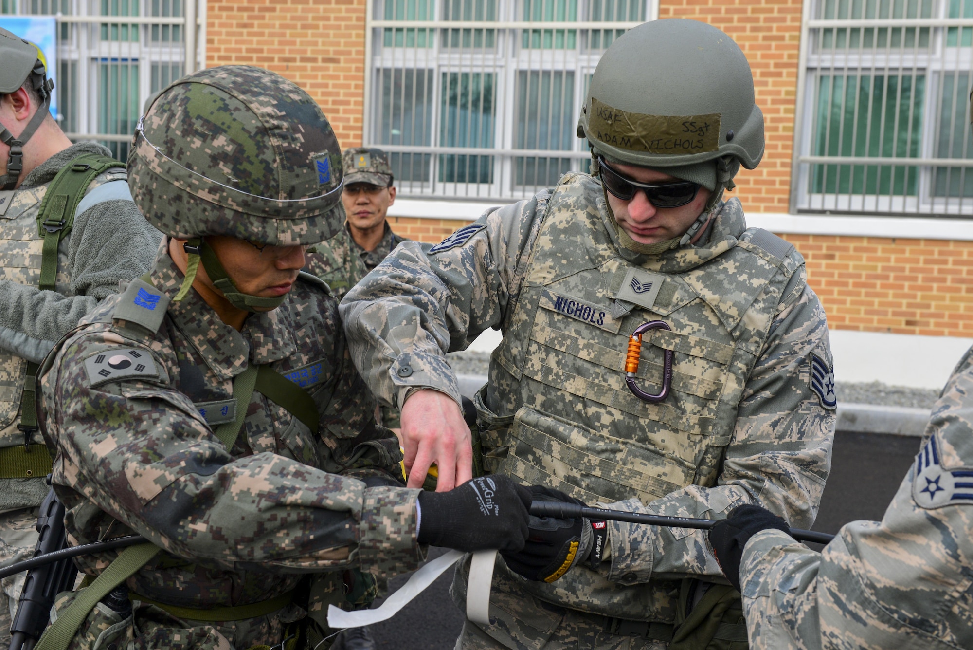 U.S. Air Force Staff Sgt. Adam Nichols, 51st Communications Squadron cable and antenna technician, works alongside a Republic of Korea air force senior master sergeant during a joint communications exercise at Gwanju Air Base, ROK, Dec. 13, 2016. The exercise allowed the U.S. and ROK Airmen to share their expertise and operating procedures, furthering their ability to work together in the field. (U.S. Air Force photo by Senior Airman Victor J. Caputo)