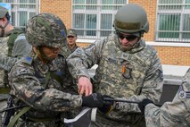 U.S. Air Force Staff Sgt. Adam Nichols, 51st Communications Squadron cable and antenna technician, works alongside a Republic of Korea air force senior master sergeant during a joint communications exercise at Gwanju Air Base, ROK, Dec. 13, 2016. The exercise allowed the U.S. and ROK Airmen to share their expertise and operating procedures, furthering their ability to work together in the field. (U.S. Air Force photo by Senior Airman Victor J. Caputo)