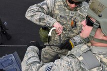 U.S. Air Force Senior Airman Ryan Dodge and Staff Sgt. Adam Nichols, 51st Communications Squadron cable and antenna technicians, open a damaged network cable during a joint communications exercise at Gwanju Air Base, Republic of Korea, Dec. 13, 2016. Several members of the 51st CS worked with their communications technician counterparts at Gwanju during the exercise, which was the first of its kind. (U.S. Air Force photo by Senior Airman Victor J. Caputo)