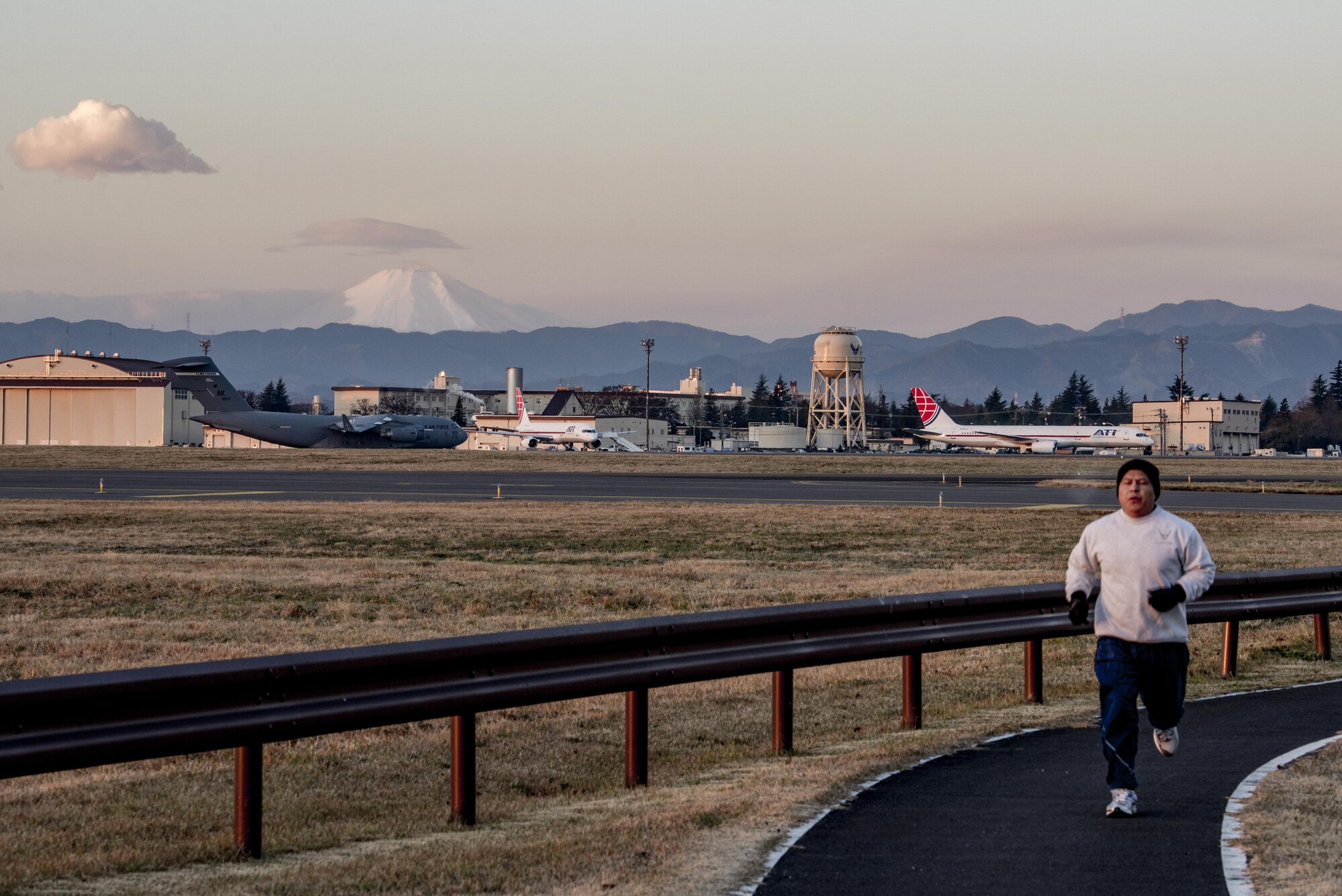 Master Sgt. Edward M. Silversmith, 374th Maintenance Squadron flight chief, runs along flight line on Dec. 9, 2016, at Yokota Air Base, Japan. Silversmith’s favorite place to run in Japan is along the flight line at Yokota in the mornings with Mt. Fuji in the background. (U.S. Air Force photo by Airman 1st Class Donald Hudson)