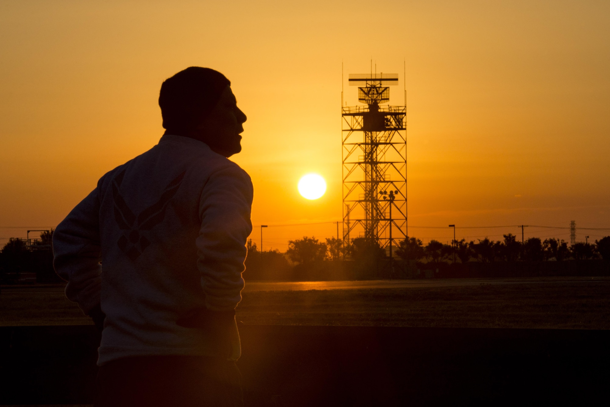 Master Sgt. Edward M. Silversmith, 374th Maintenance Squadron flight chief, cools down after a morning run as the sun rises on Dec. 9, 2016, at Yokota Air Base, Japan. In Navajo culture it is customary to get up before the sun rise and do the ritual followed by a run east towards the rising sun. (U.S. Air Force photo by Airman 1st Class Donald Hudson)