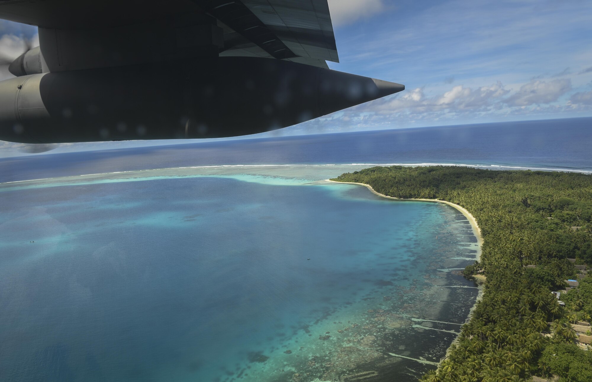 A C-130H Hercules assigned to the 36th Airlift Squadron flies over a Pacific island during Operation Christmas Drop, Dec. 11, 2016. The operation highlights the U.S. and allied airpower capabilities to orient and respond to activities in peacetime and crisis. In addition to delivering critical supplies to those in need, Operation Christmas Drop provides specific training to U.S. and allied aircrews, enabling theater-wide airpower. (U.S. Air Force photo by Senior Airman Elizabeth Baker)
