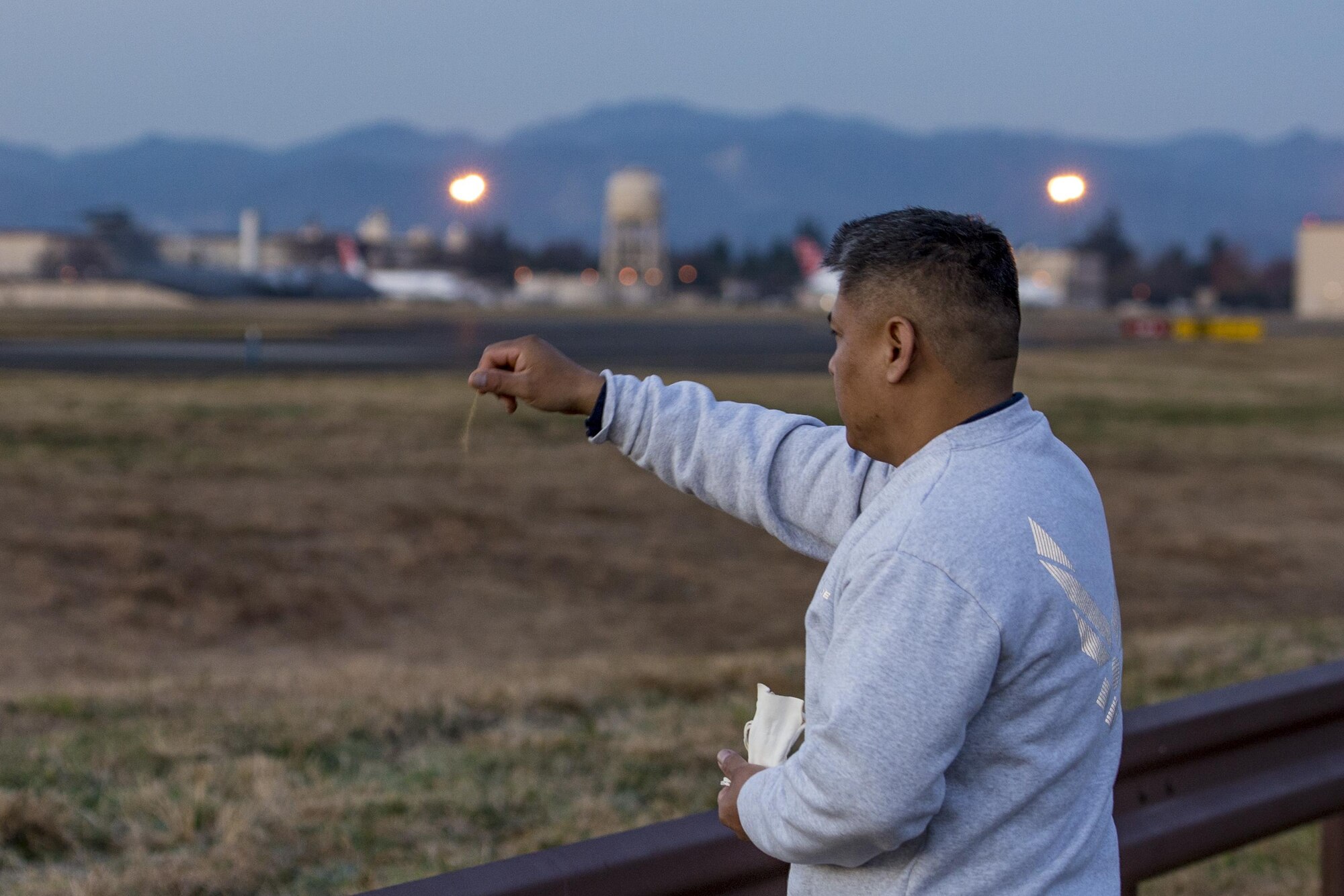 Master Sgt. Edward M. Silversmith, 374th Maintenance Squadron flight chief, performs a traditional Navajo morning ritual and prayer while sprinkling an offering of corn pollen on Dec. 9, 2016, at Yokota Air Base, Japan. In Navajo culture, it is customary to get up before the sun rise and do the ritual followed by a run east towards the rising sun. (U.S. Air Force photo by Airman 1st Class Donald Hudson)