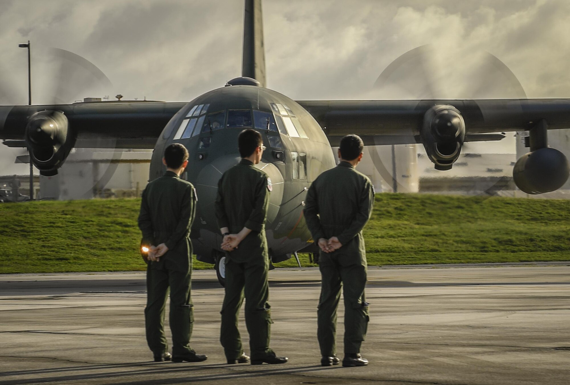 Members of the Japan Air Self Defense Force stand at parade rest as a C-130H Hercules begins to taxi for takeoff during Operation Christmas Drop at Andersen Air Force Base, Guam, Dec. 7, 2016. This year the U.S. Air Force, Royal Australian air force and JASDF worked together to continue the tradition of air dropping tools, food, clothing and toys throughout the Pacific. (U.S. Air Force photo by Senior Airman Elizabeth Baker/Released)