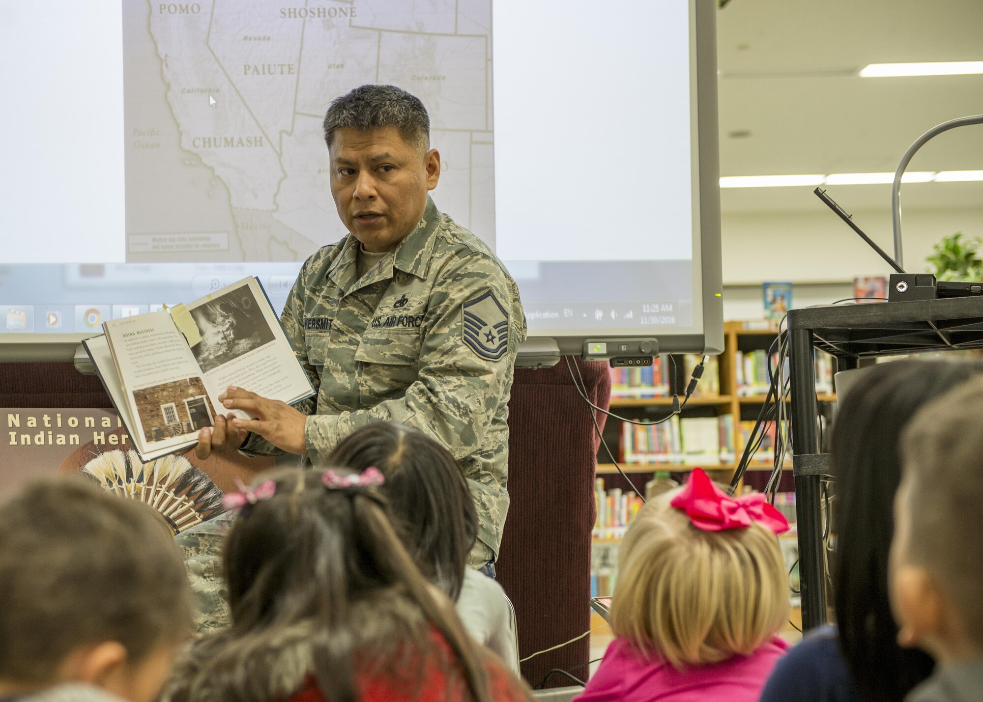 Master Sgt. Edward M. Silversmith, 374th Maintenance Squadron flight chief, reads to children at Mendel Elementary School during a National American Indian Heritage Month event on Nov. 30, 2016, at Yokota Air Base, Japan. Yokota’s NAIHM committee held more than 30 reading sessions at Yokota elementary schools. (U.S. Air Force photo by Airman 1st Class Donald Hudson)