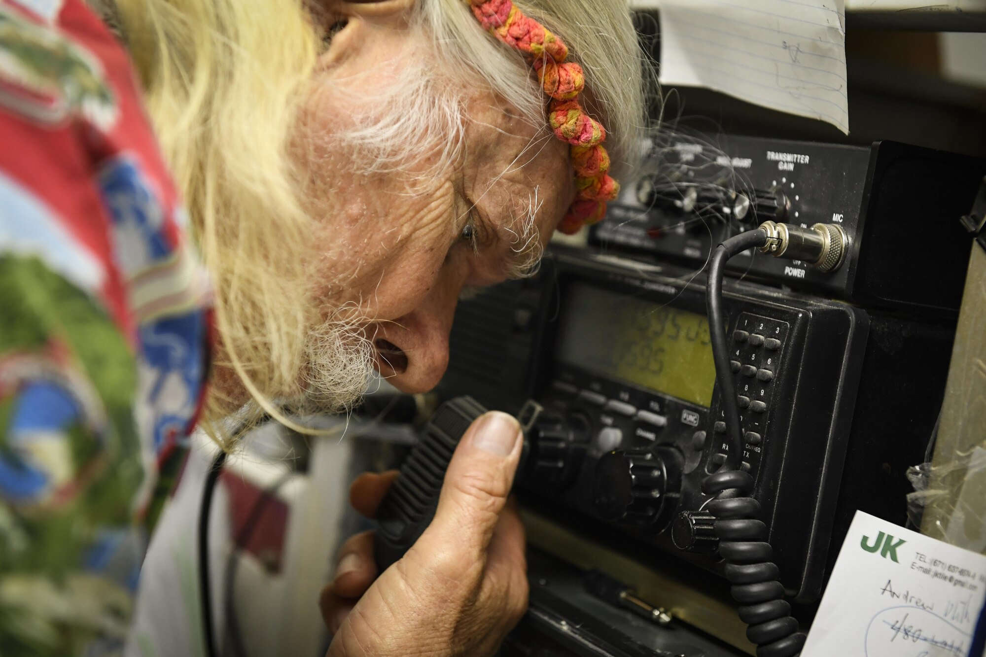 Bruce Best, University of Guam researcher, communicates with a 36th Airlift Squadron C-130H Hercules aircrew during Operation Christmas Drop, at the University of Guam, Guam, Dec. 7, 2016. Every December, C-130H Hercules aircrews from Yokota head to Andersen Air Force Base to execute low-cost, low-altitude humanitarian airdrops to islanders throughout the Commonwealth of the Northern Marianas, Federated States of Micronesia and Republic of Palau. Best is the line of communication between the islands and the aircrews, ensuring that each LCLA arrives safely at its drop zone. (U.S. Air Force photo by Senior Airman Elizabeth Baker)
