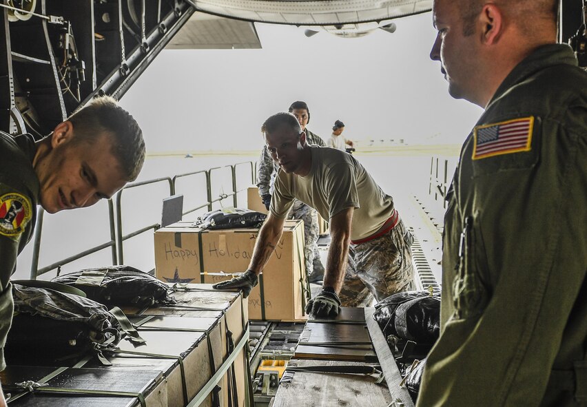 36th Airlift Squadron loadmasters load bundles of donated goods onto a C-130H Hercules during Operation Christmas Drop 2016 at Andersen Air Force Base, Guam, Dec. 9, 2016. Every December, C-130H Hercules aircrews from Yokota Air Base, Japan, head to Andersen Air Force Base to execute low-cost, low-altitude humanitarian airdrops to islanders throughout the Commonwealth of the Northern Marianas, Federated States of Micronesia and Republic of Palau. (U.S. Air Force photo by Senior Airman Elizabeth Baker)