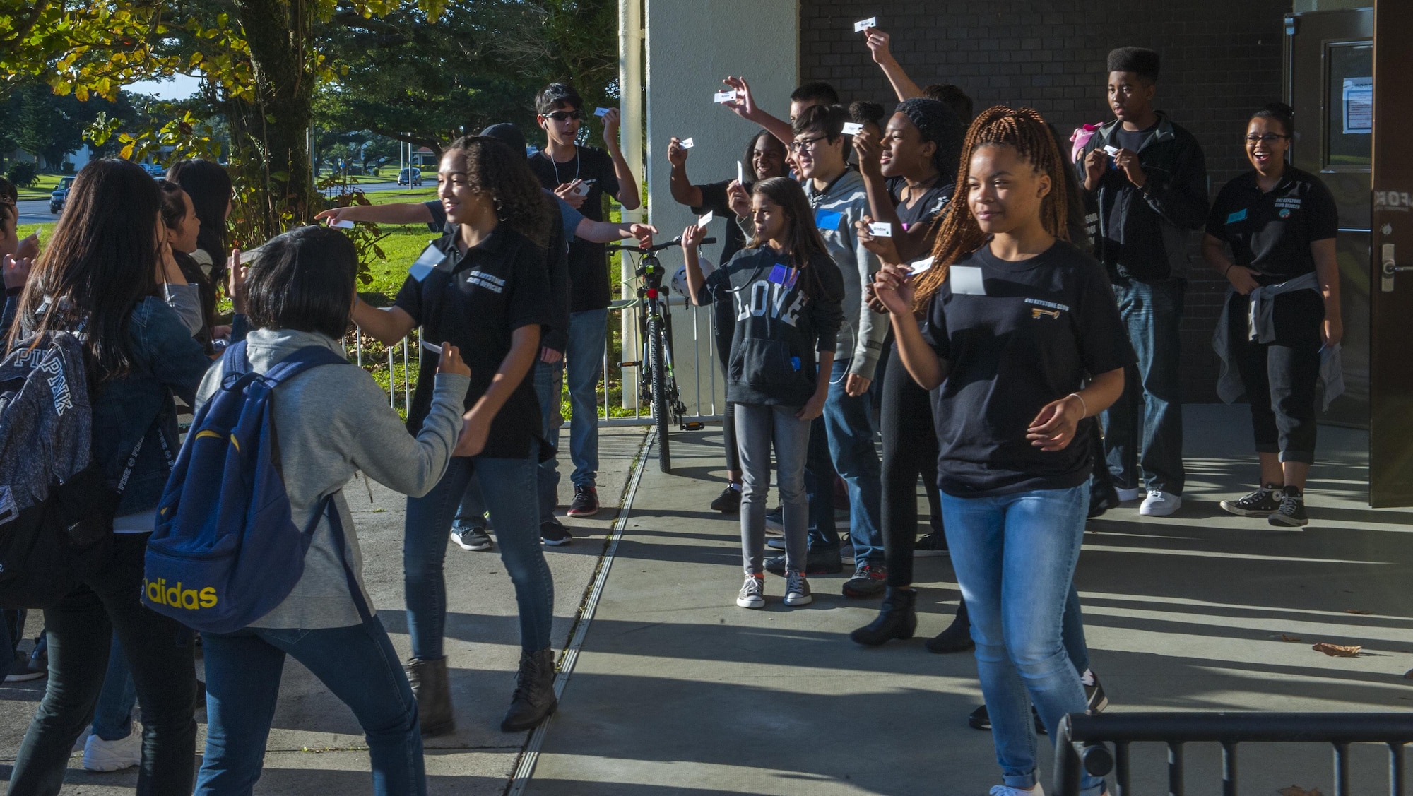Students from Okinawa and Department of Defense school districts partner up outside of the teen center for a cultural exchange event, Dec. 17, 2016, Kadena Air Base, Japan. The students played games and enjoyed a holiday meal together as part of a cultural exchange between the two communities. (U.S. Air Force photo by Airman 1st Class Nick Emerick/Released) 