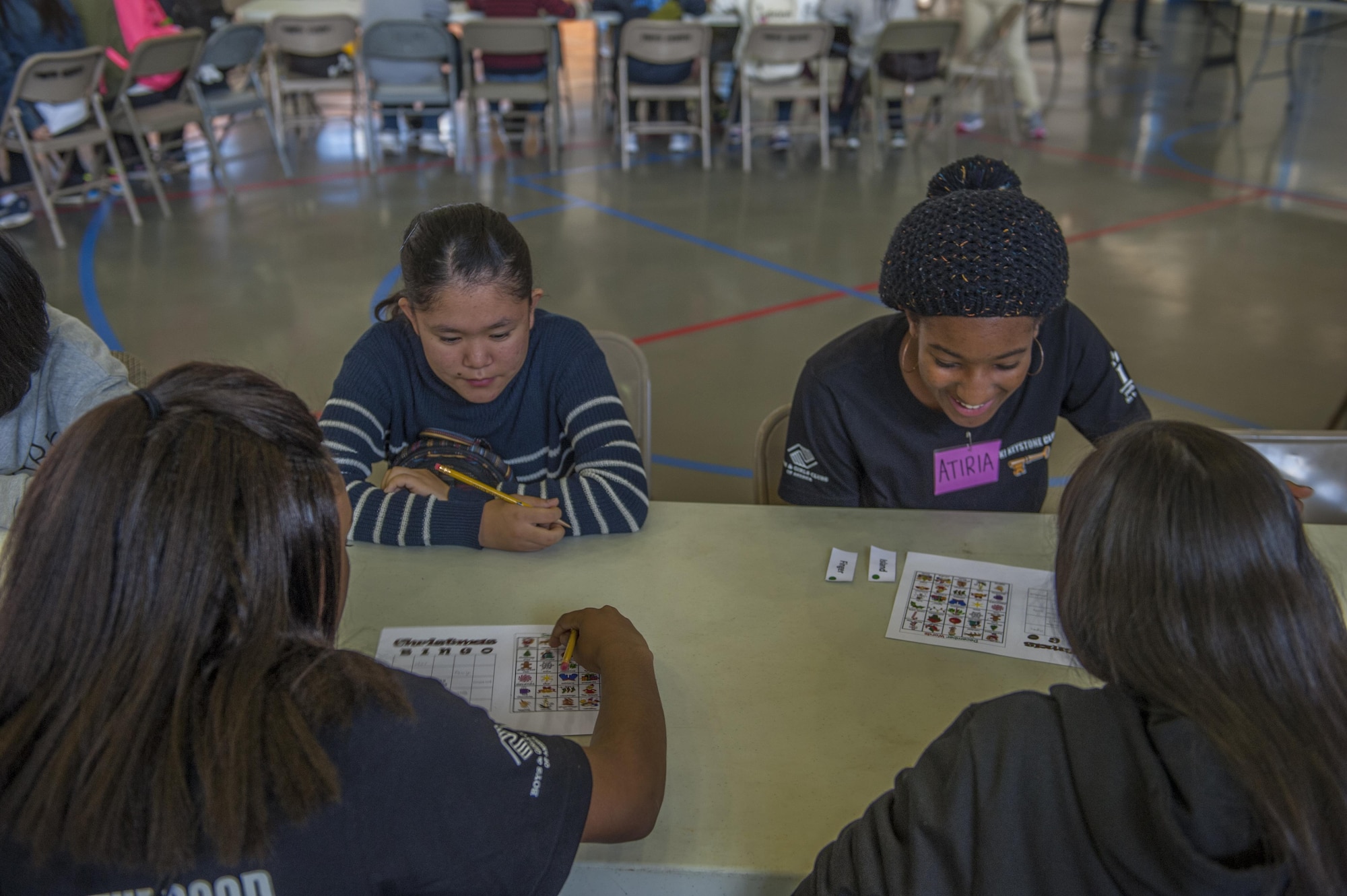 Okinawan school children play holiday bingo with students from Department of Defense school district, Dec. 17, 2016, at the teen center on Kadena Air Base, Japan. The event introduced some aspects of American culture and was an opportunity for all participants to make new friends. (U.S. Air Force photo by Airman 1st Class Nick Emerick/Released)