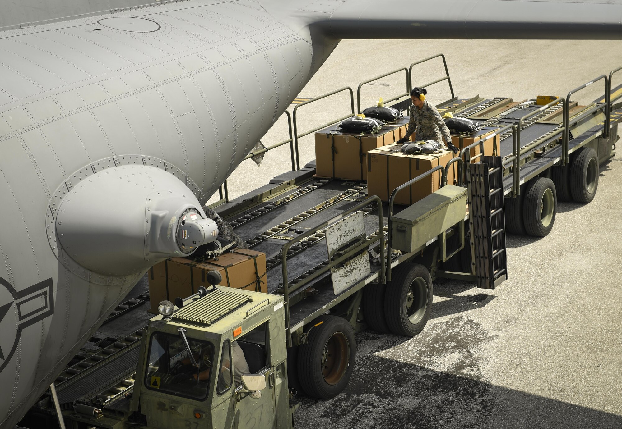 Members of  Team Andersen load bundles of donated good onto a 36th Airlift Squadron C-130H Hercules for Operation Christmas Drop 2016 at Andersen Air Force Base, Guam, Dec. 10, 2016. Operation Christmas Drop highlights the U.S. and allied airpower capabilities to orient and respond to activities in peacetime and crisis. (U.S. Air Force photo by Senior Airman Elizabeth Baker)