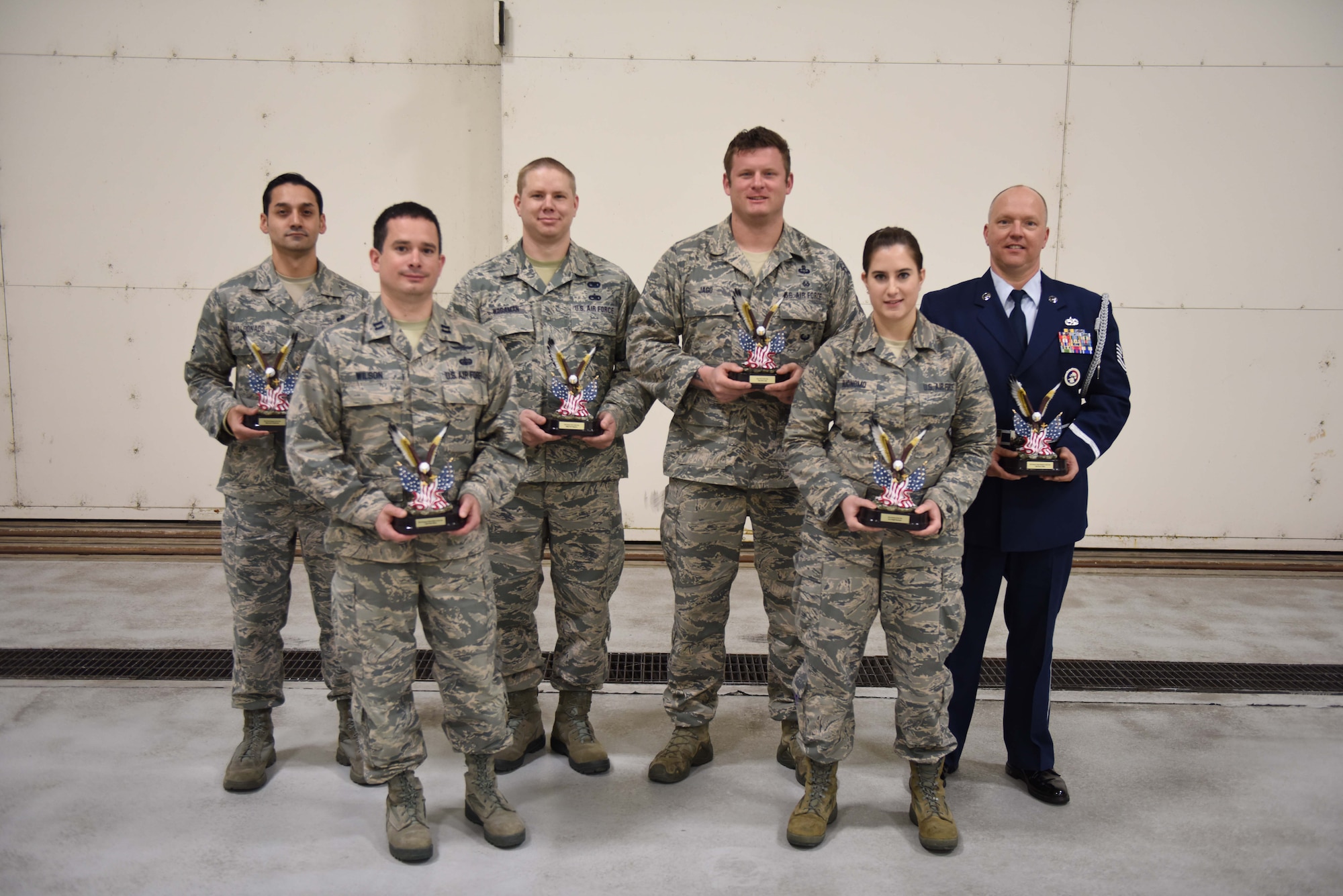 Master Sgt. Jason Maldonado, Capt. Colin Wilson, Master Sgt. Paul Wagaman, Tech. Sgt. Brent David Miller, Tech. Sgt. Ethan Jago, Senior Airman Abigail Buonomo (left to right), members of the 193rd Special Operations Wing, Middletown, Pennsylvania, receive their Airmen of the Year Awards Dec. 18, during the wing’s annual awards ceremony. The awards were earned for outstanding performance and leadership that impact the wing’s mission but also support fellow Airman associated with the Air National Guard. (U.S. Air National Guard photo by Senior Airman Ethan Carl/Released)