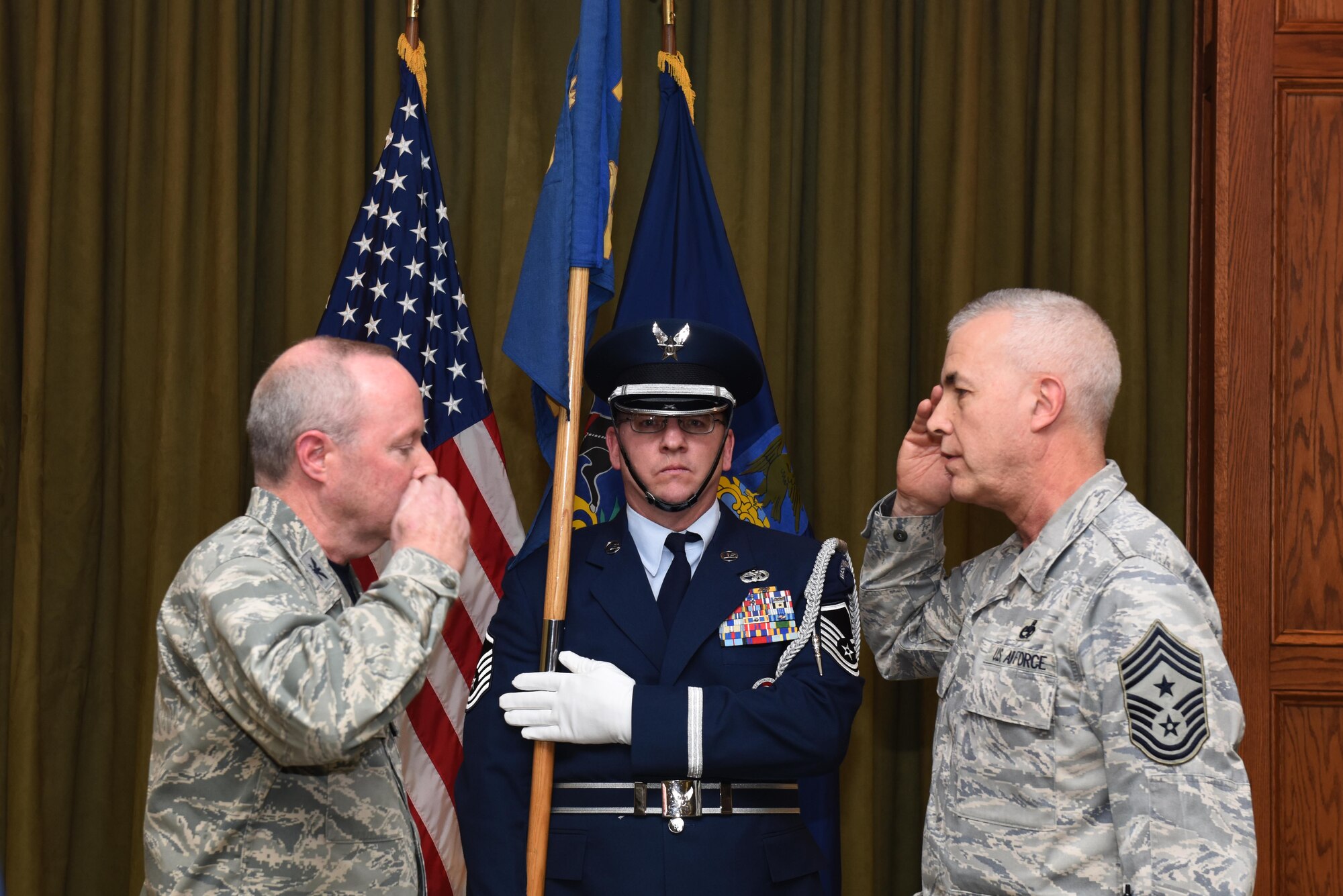Former State Command Chief Master Sgt. Victor Guerra salutes Col. Mike Regan, Commander, Pennsylvania Air National Guard, as he states, “Sir, I relinquish responsibility,” as he retires from the position he’s held since October 2011. The change of responsibly ceremony includes the passing of the guidon, a symbolic representation of the relinquishment and acceptance of the position, as well as verbal acknowledgement of the position change. (U.S. Air National Guard Photo by Tech. Sgt. Claire Behney/Released)