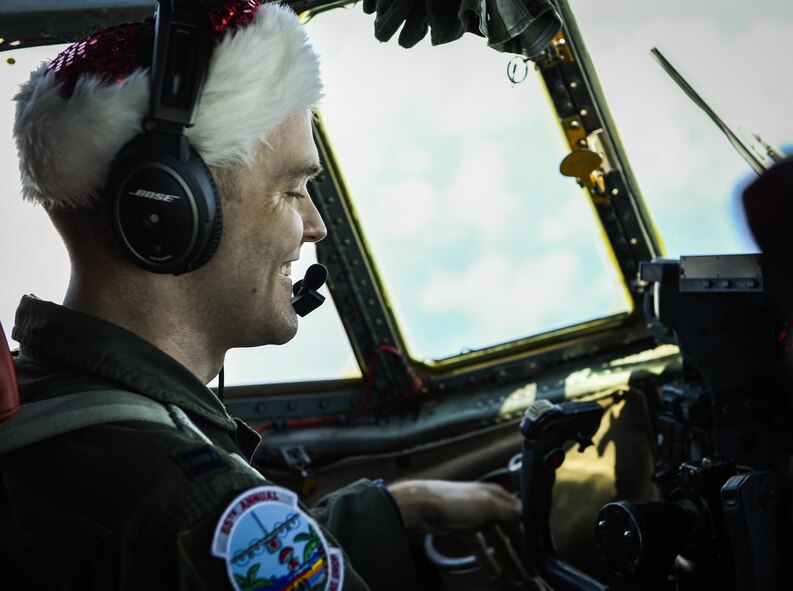 Capt. Jody Robertson, 36th Airlift Squadron flight commander, pilots a C-130H Hercules during Operation Christmas Drop over the Pacific islands, Dec. 11, 2016. The operation highlights the U.S. and allied airpower capabilities to orient and respond to activities in peacetime and crisis. In addition to delivering critical supplies to those in need, Operation Christmas Drop provides specific training to U.S. and allied aircrews, enabling theater-wide airpower. (U.S. Air Force photo by Senior Airman Elizabeth Baker)