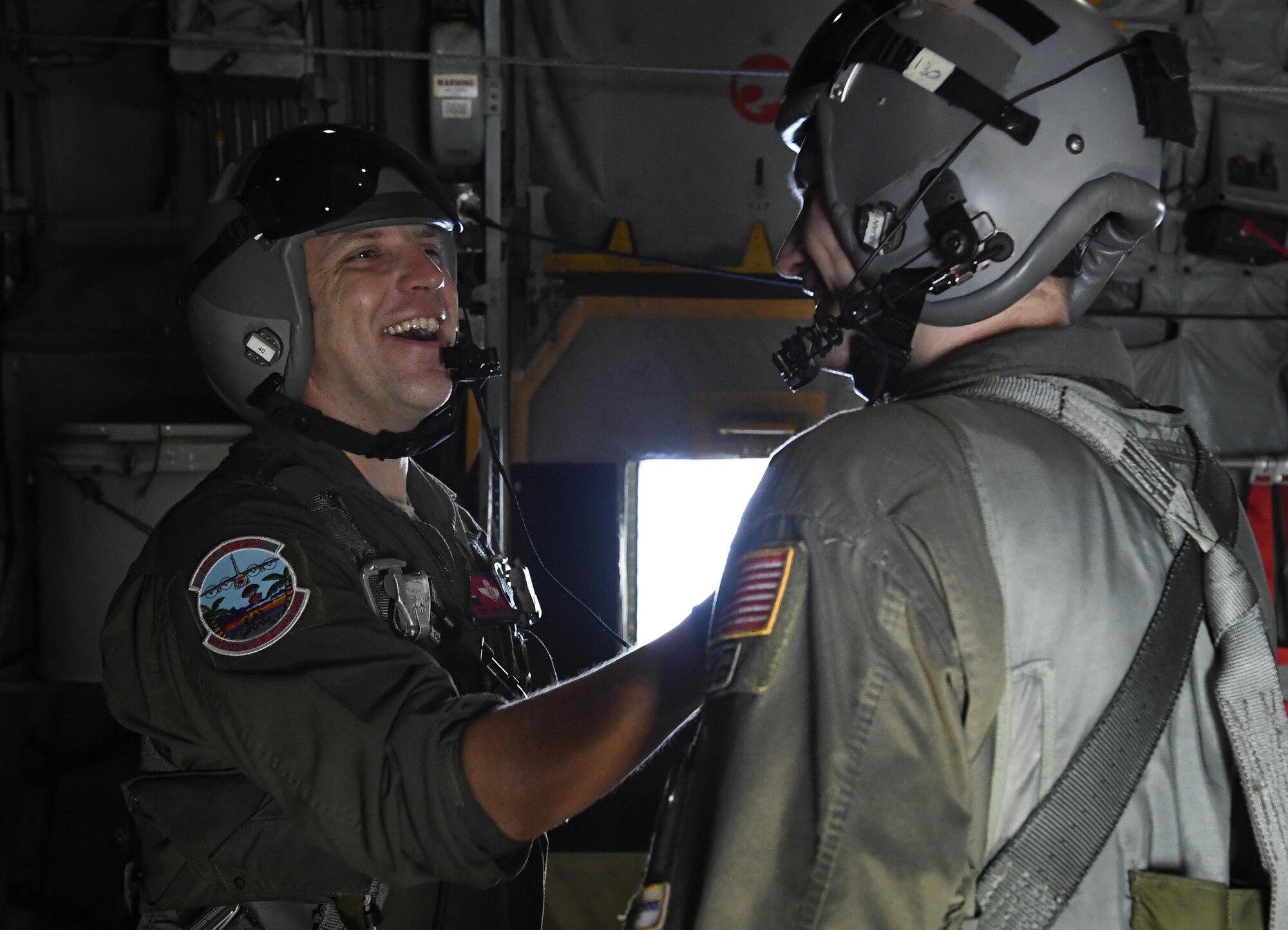 Tech. Sgt. Jonathan Lange, left, 36th Airlift Squadron C-130H Hercules instructor loadmaster, and Senior Airman Nicholas Oswald, 36 AS C-130H Hercules loadmaster, wait to airdrop bundles of donated goods over the Pacific islands during Operation Christmas Drop 2016, Dec. 11, 2016. Every December, C-130H Hercules aircrews from Yokota head to Andersen Air Force Base to execute low-cost, low-altitude humanitarian airdrops to islanders throughout the Commonwealth of the Northern Marianas, Federated States of Micronesia and Republic of Palau. (U.S. Air Force photo by Senior Airman Elizabeth Baker)