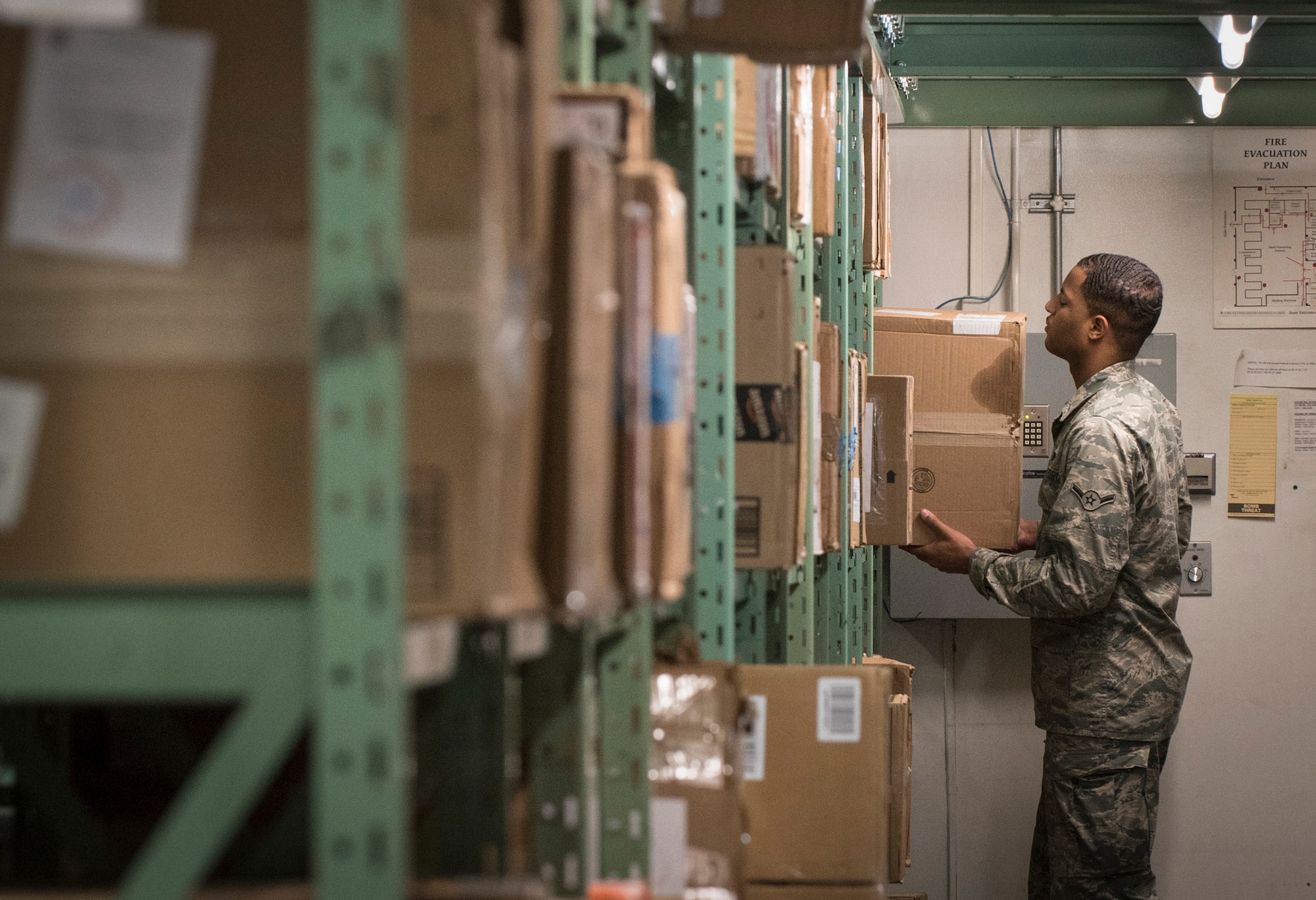 U.S. Air Force Airman Timothy Houston, a 35th Communications Squadron postal clerk, grabs a package from a shelf at Misawa Air Base, Japan, Dec. 15, 2016. Although stateside installation post offices are ran by civilian contractors, overseas post offices are powered by selected 35th CS Airmen. Hours of operation are Monday through Friday, 10 a.m. - 6 p.m., Saturday, 10 a.m. - 4 p.m. and Sunday, 1 p.m. - 3 p.m. (U.S. Air Force photo by Airman 1st Class Sadie Colbert)
