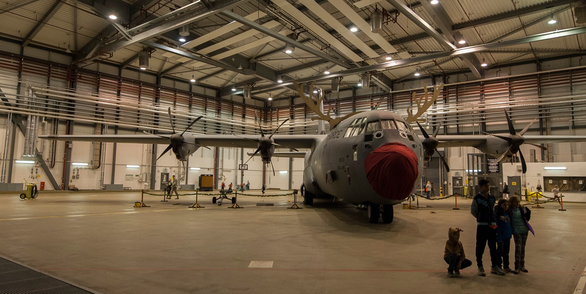 A C-130J Super Hercules sits in a hangar at Ramstein Air Base, Germany, Dec. 16, 2016. Santa opened a workshop at the Dual-Bay Complex here and invited families across the community to participate in holiday festivities. (U.S. Air Force photo by Airman 1st Class Lane T. Plummer)