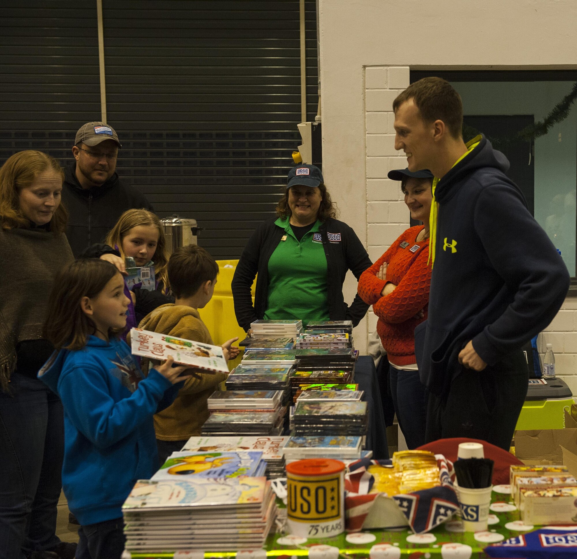 USO volunteers serve families at a Christmas event held at Ramstein Air Base, Germany, Dec. 16, 2016. Hundreds of community members showed up to the event, participating in Santa’s workshop and celebrating the holidays. (U.S. Air Force photo by Airman 1st Class Lane T. Plummer)