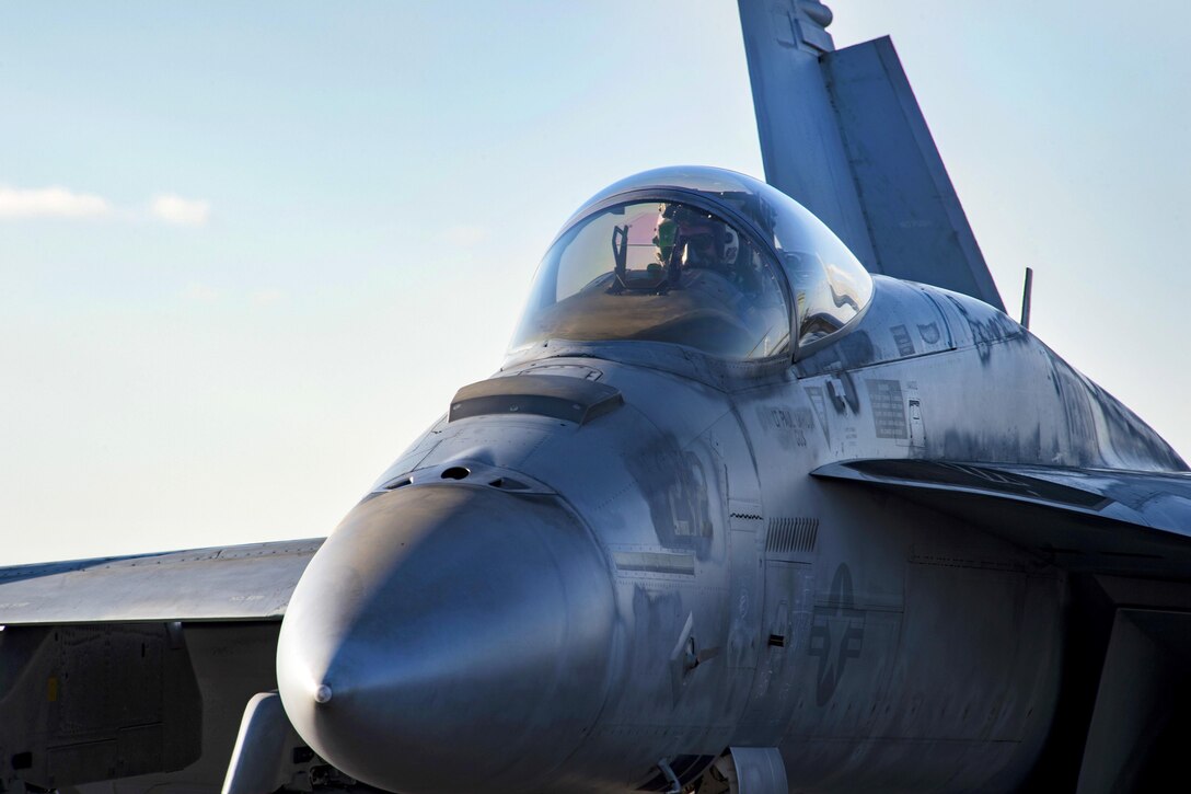 A pilot sits in an F/A-18E Super Hornet on the flight deck of the aircraft carrier USS Dwight D. Eisenhower in the Mediterranean Sea, Dec. 10, 2016. The Hornet is assigned to Strike Fighter Squadron 86. Navy photo by Petty Officer 3rd Class Nathan T. Beard