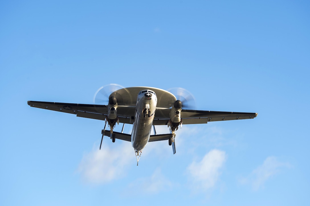 An E2-C Hawkeye flies above the flight deck of the aircraft carrier USS Dwight D. Eisenhower in the Mediterranean Sea, Dec. 10, 2016. The Hawkeye is assigned to Airborne Early Warning Squadron 130. Navy photo by Petty Officer 3rd Class Nathan T. Beard