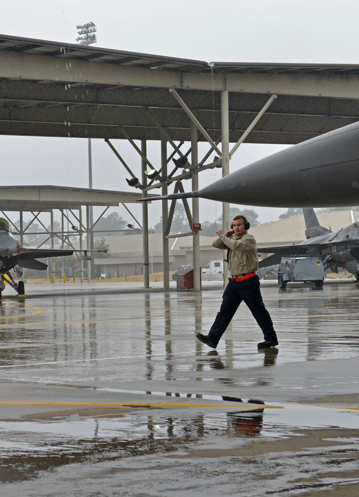 U.S. Air Force Airman 1st Class Zachary Rogers, 20th Aircraft Maintenance Squadron tactical aircraft maintainer, prepares to marshal out an F-16CM Fighting Falcon at Shaw Air Force Base, S.C., Dec. 13, 2016. Tactical aircraft maintainers use hand signals to communicate with pilots while the aircraft’s engine is running. (U.S. Air Force photo by Airman 1st Class Destinee Sweeney)