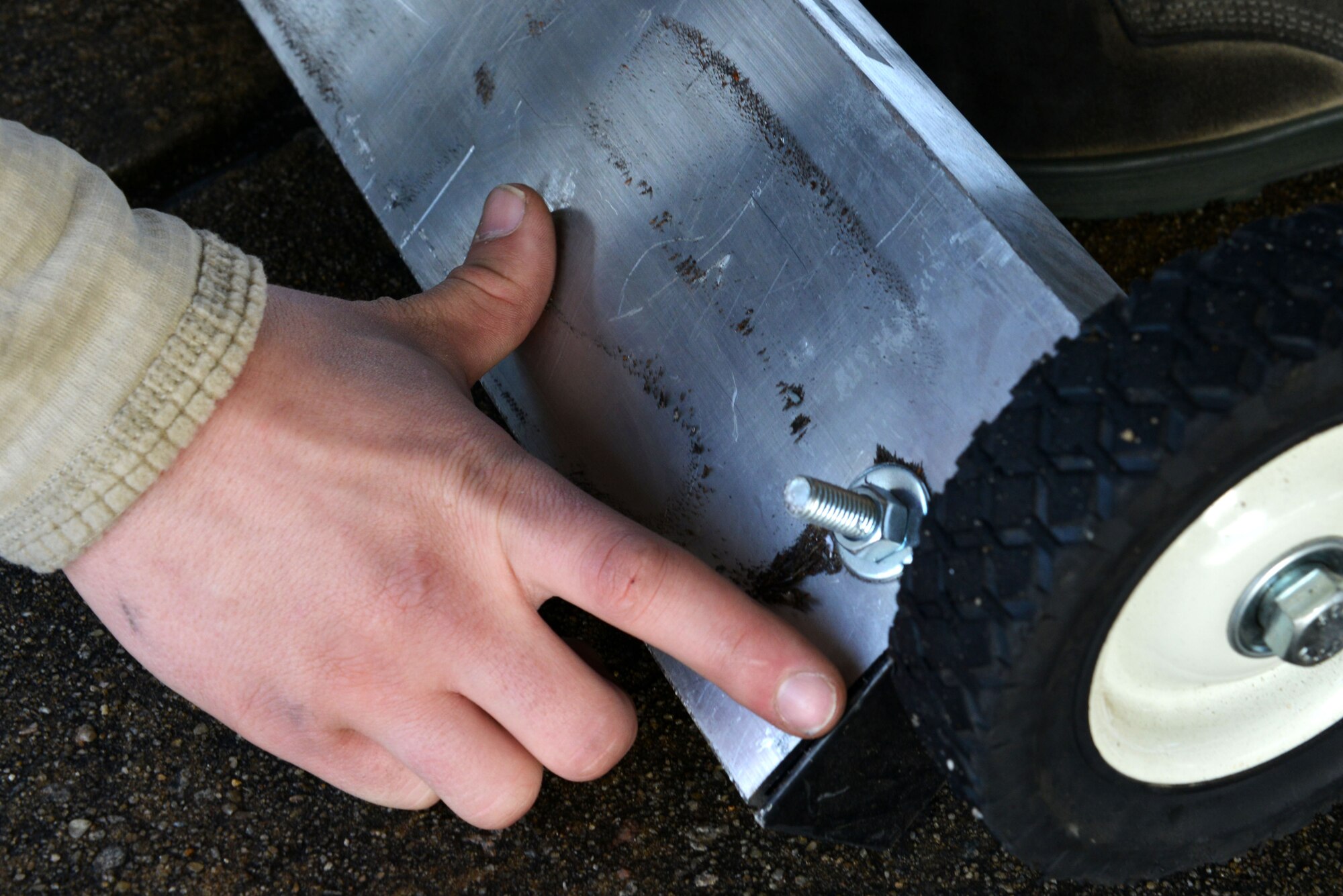 U.S. Air Force Senior Airman Zachary Jinkins, 20th Aircraft Maintenance Squadron tactical aircraft maintainer, searches for foreign object debris (FOD) on a magnet at Shaw Air Force Base, S.C., Dec. 14, 2016. FOD, any loose item or substance on the flightline, can cause damage to an aircraft if sucked into the intake. (U.S. Air Force photo by Airman 1st Class Destinee Sweeney)