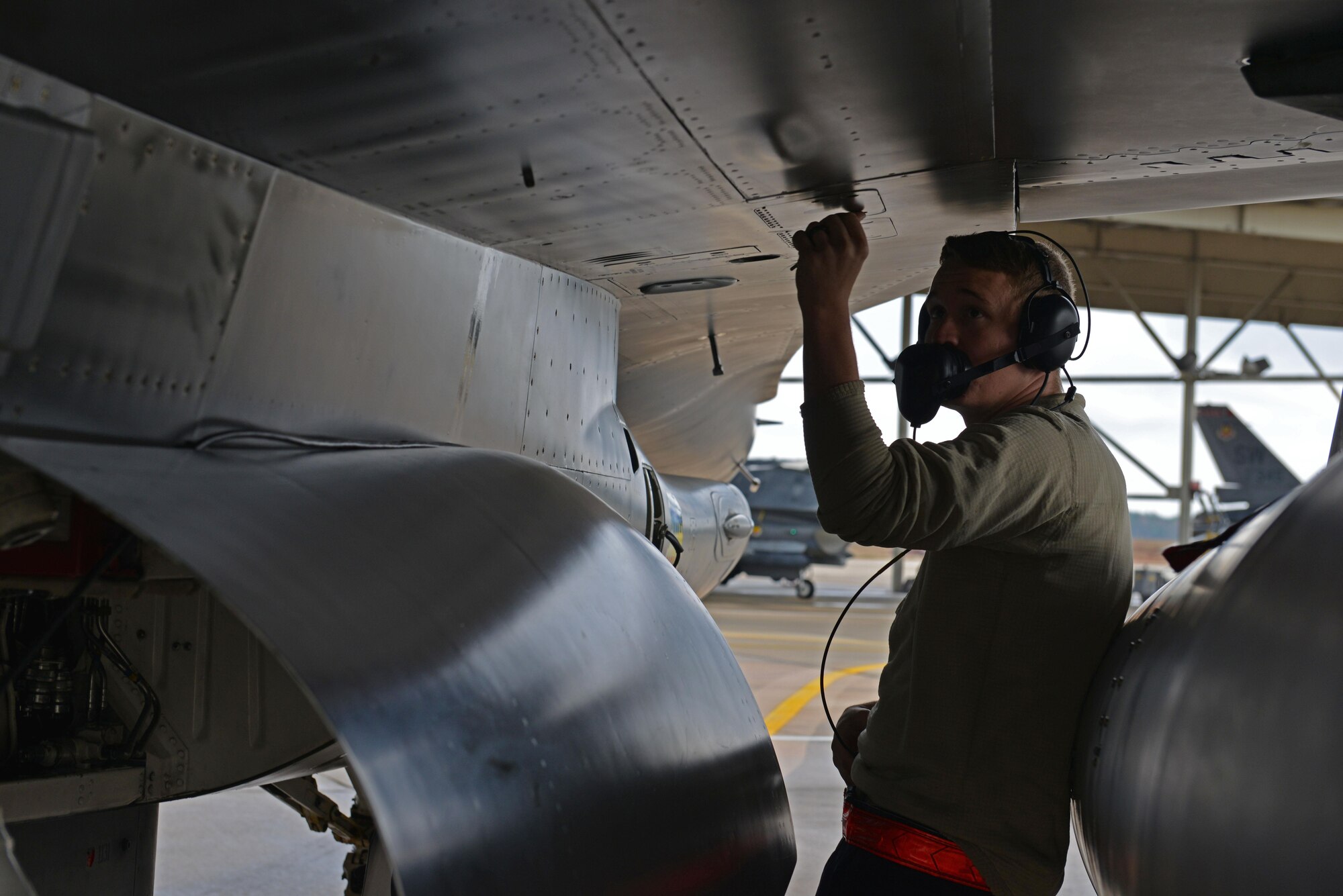 U.S. Air Force Senior Airman Zachary Jinkins, 20th Aircraft Maintenance Squadron tactical aircraft maintainer, performs a final inspection on an F-16CM Fighting Falcon at Shaw Air Force Base, S.C., Dec. 14, 2016. To ensure the safety of pilots, F-16s are inspected for mechanical failures, leaks and loose panels by tactical aircraft maintainers prior to flight. (U.S. Air Force photo by Airman 1st Class Destinee Sweeney)