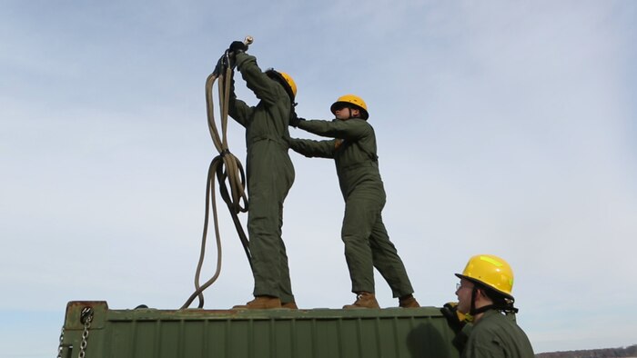 Embarkation Specialists Lance Cpls. Sandre E. Flournoy and Jason B. Embile, both with Logistics Platoon, Chemical Biological Incident Response Force, CBIRF, rehearse proper hooking procedures prior to a sling load operation as part of Initial Reaction Force B certification exercise, CERTEX, aboard Naval Support Facility Indian Head Annex Stump Neck, Md., Dec. 13, 2016. This CERTEX evaluated all sections composing the IRF including identification and detection, technical rescue, decontamination, search and rescue/casualty extraction, medical, explosive ordnance disposal, as well as command and control.  (Official U.S. Marine Corps photo by Staff Sgt. Santiago G. Colon Jr./RELEASED)
