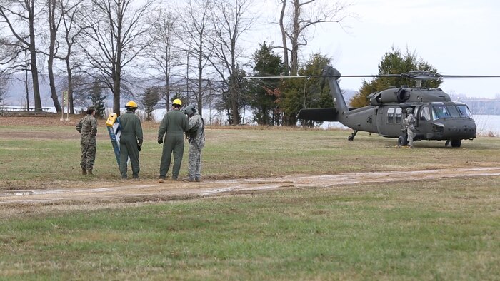 Marines with Logistics Platoon, Chemical Biological Incident Response Force, CBIRF, speak to an Army pilot of An UH-60 Blackhawk helicopter assigned to 12th Aviation Battalion, U.S. Army, prior to a sling load operation as part of Initial Reaction Force B certification exercise, CERTEX, aboard Naval Support Facility Indian Head Annex Stump Neck, Md., Dec. 13, 2016. This CERTEX evaluated all sections composing the IRF including identification and detection, technical rescue, decontamination, search and rescue/casualty extraction, medical, explosive ordnance disposal, as well as command and control.  (Official U.S. Marine Corps photo by Staff Sgt. Santiago G. Colon Jr./RELEASED)
