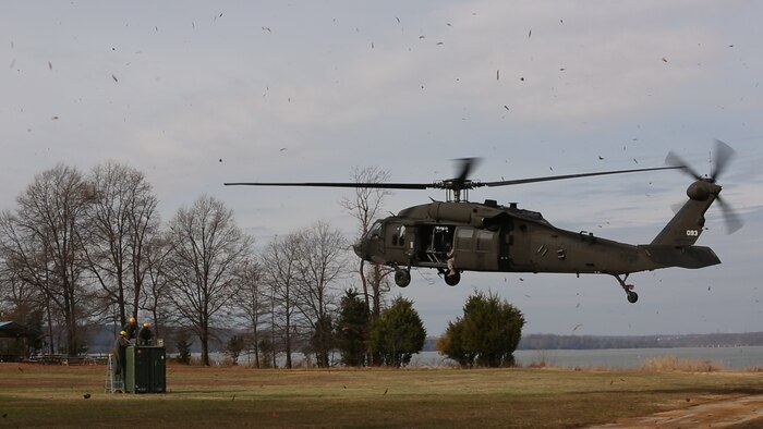 Embarkation specialist Marines with Chemical Biological Incident Response Force, CBIRF, prepare to attach a container of supplies to an UH-60 Blackhawk helicopter assigned to 12th Aviation Battalion, U.S. Army, during a sling load operation as part of Initial Reaction Force B certification exercise, CERTEX, aboard Naval Support Facility Indian Head Annex Stump Neck, Md., Dec. 13, 2016. This CERTEX evaluated all sections composing the IRF including identification and detection, technical rescue, decontamination, search and rescue/casualty extraction, medical, explosive ordnance disposal, as well as command and control.  (Official U.S. Marine Corps photo by Staff Sgt. Santiago G. Colon Jr./RELEASED)
