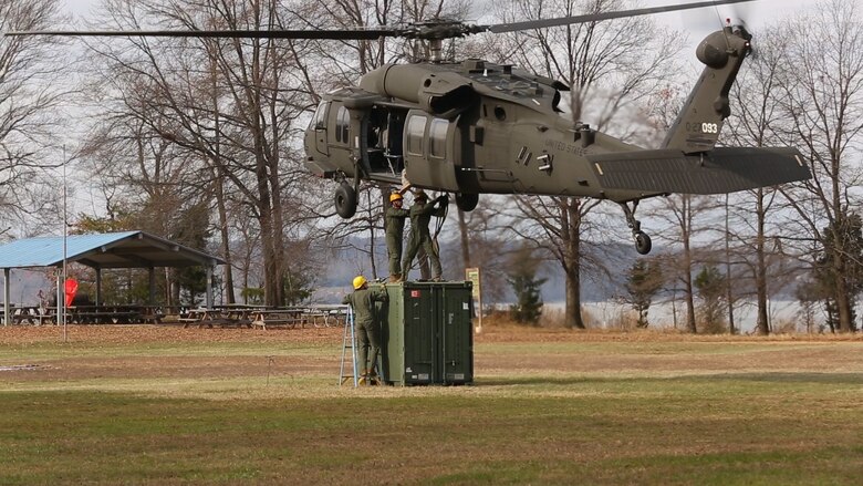 Embarkation specialist Marines with Chemical Biological Incident Response Force, CBIRF, attach a container of supplies to an UH-60 Blackhawk helicopter during a sling load operation as part of Initial Reaction Force B certification exercise, CERTEX, aboard Naval Support Facility Indian Head Annex Stump Neck, Md., Dec. 13, 2016. This CERTEX evaluated all sections composing the IRF including identification and detection, technical rescue, decontamination, search and rescue/casualty extraction, medical, explosive ordnance disposal, as well as command and control.  (Official U.S. Marine Corps photo by Staff Sgt. Santiago G. Colon Jr./RELEASED)
