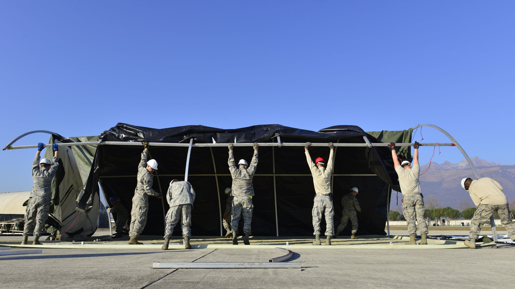 Airmen from the 31st Civil Engineer Squadron construct a tent during an exercise at Aviano Air Base, Italy on Dec. 15, 2016. The exercise was designed to test Team Aviano’s capabilities. (U.S. Air Force photo by Senior Airman Cary Smith)