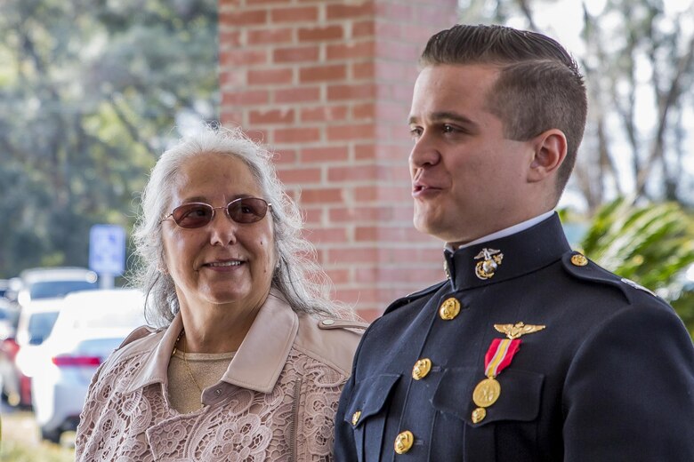 An officer escorts a guest during the Marine Corps Air Station Beaufort Officers’ Spouses’ Club’s senior citizen’s tea aboard MCAS Beaufort, Dec. 11. This year marks the 47th annual tea held to honor and serve the senior citizens of the Beaufort area, many of whom are former service members or spouses of former service members.