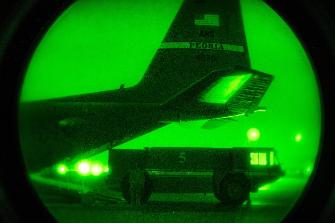 As seen through a night vision device, airmen prepare a C-130H Hercules aircraft for cargo in Iraq, Dec. 15, 2016. Air Force photo by Senior Airman Jordan Castelan