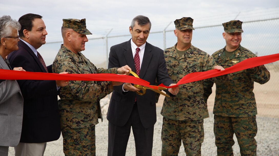 (Left to Right) Arizona State Senator and Supervisor-elect, Lynne Pancrazi, City of Yuma Mayor, Douglas J. Nicholls, Maj. Gen. commander of Marine Corps Installations Command, John J. Broadmeadow, executive vice president and chief operation officer of Arizona Public Service (APS), Mr. Mark A. Schiavoni, commanding general of Marine Corps Installations West Brig. Gen. Kevin Killea, and Marine Corps Air Station Yuma commanding officer, Col. Ricardo Martinez, cut a ceremonial ribbon signifying the opening of the microgrid site during the APS ribbon cutting ceremony, Thursday, Dec. 15, 2016 at MCAS Yuma, Ariz.The microgrid project is a partnership between APS and MCAS Yuma that will provide 100 percent energy coverage base-wide, mitigate external electrical grid failures, and provide enough backup power to cover the base’s current and projected energy requirements.