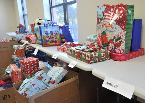 Christmas gifts are organized for distribution on tables during Operation Angel Tree at the Tyndall Air Force Base, Fla., Chapel Dec. 16, 2016. The First Sergeants Group along with the Tyndall Spouses Club and Chapel staff provided presents to 225 children in 128 Tyndall affiliated families. The event mainly focuses to help single income and large families. Tyndall volunteers devoted more than 140 hours of planning and collection into the event. (U.S. Air Force photo by Senior Airman Ty-Rico Lea/Released)