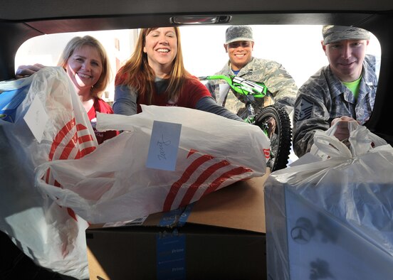 The Tyndall Spouses Club and First Sergeants Group load donated children’s gifts during Operation Angel Tree at the base Thrift Shop on Tyndall Air Force Base, Fla., Dec. 16, 2016. Operation Angel Tree provided gifts to 225 children from 128 Tyndall families. (U.S. Air Force photo by Senior Airman Ty-Rico Lea/Released)
