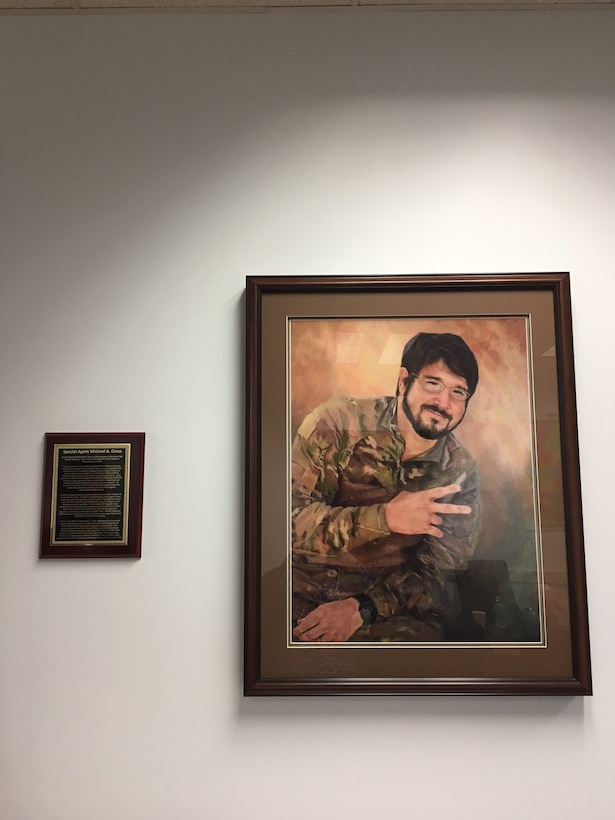 Inside the newly dedication Special Agent Michael A. Cinco Facility at Beale Air Force Base, Calif., is a framed portrait and biography of the Fallen Agent killed in action Dec. 21, 2015, near Bagram Air Field, Afghanistan. (U. S. Air Force photo/Airman Tristan D. Viglianco 9 RW/PA) 