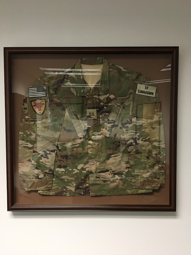 Inside the newly dedicated Special Agent Michael A. Cinco Facility at Beale Air Force Base, Calif., is a shadow box with SA Cinco's utility uniform he wore as a member of Team Crimson in Afghanistan. (U.S. Air Force photo/Airman Tristan D. Viglianco 9 RW/PA)  