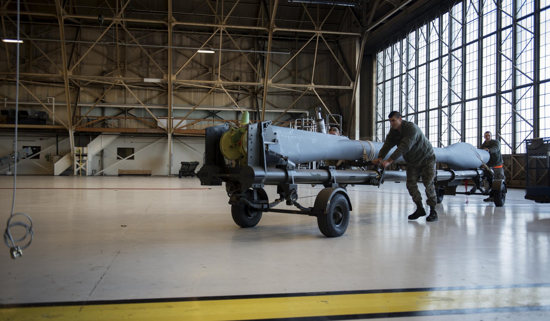 Airmen from the 92nd Maintenance Squadron hydraulics shop move a new boom into position to be attached to a KC-135 Stratotanker Dec. 16, 2016, at Fairchild Air Force Base, Wash. The Airmen submitted a correction form to amend the KC-135 technical orders Airmen reference when repairing aircraft. Their request for change was approved and the Air Force-wide correction will be applied to all future technical order versions. (U.S. Air Force photo/ Airman 1st Class Sean Campbell)