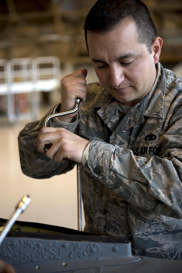 Tech. Sgt. Alfonso Vigil 92nd Maintenance Squadron hydraulics NCO in charge of dayshift, works on removing the saddle panel from the refueling boom Dec. 16, 2016, at Fairchild Air Force Base, Wash. Changes have been submitted to the KC-135 Stratotanker’s T.O. since the introduction of the aircraft in 1956 to correct errors, all in effort to make it safer for Airmen to maintain and fly the Stratotanker. (U.S. Air Force photo/ Airman 1st Class Sean Campbell)