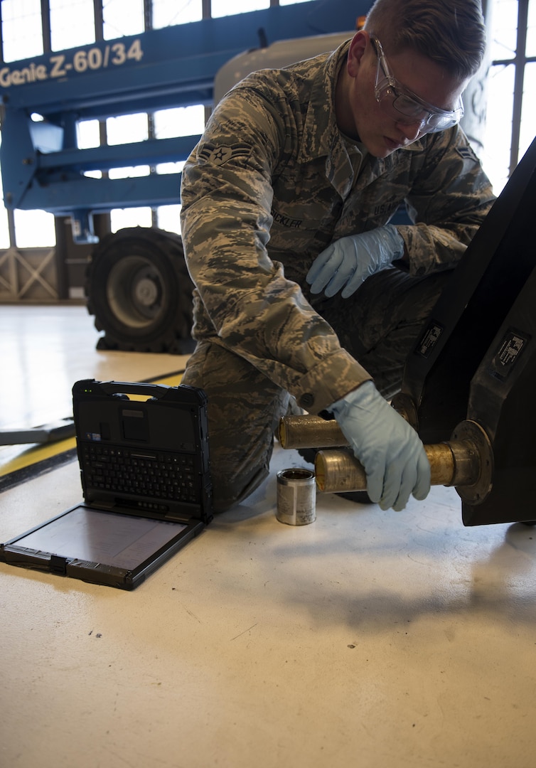 Airman 1st Class Tage Sickler 92nd Maintenance Squadron hydraulics systems apprentice, prepares to attach the ruddervators to the refueling boom Dec. 16, 2016, at Fairchild Air Force Base, Wash. There are two slots on either side of the torque tube where bolts can go through, keeping the ruddervator from rotating within the bell crank, allowing the ruddervator to be controlled. (U.S. Air Force photo/ Airman 1st Class Sean Campbell)