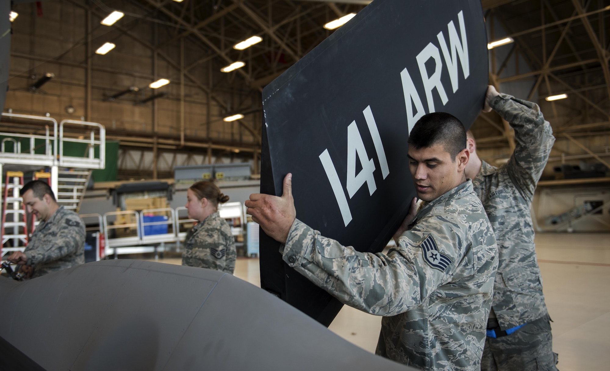 Staff Sgt. Anthony Landin, 92nd Maintenance Squadron hydraulics system craftsman, and Airman 1st Class Tage Sickler 92nd MXS hydraulics systems apprentice, install a ruddervator Dec. 16, 2016, at Fairchild Air Force Base, Wash. If any of the parts located in the ruddervator control system are installed improperly, there is the possibility of damaging the entire boom. (U.S. Air Force photo/ Airman 1st Class Sean Campbell)