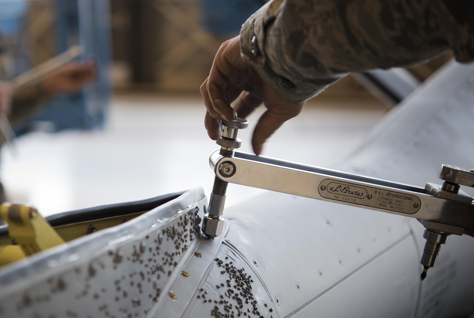 Tech. Sgt. Alfonso Vigil 92nd Maintenance Squadron hydraulics NCO in charge of dayshift, removes a stripped screw from the saddle panel located on the refueling boom Dec. 16, 2016, at Fairchild Air Force Base, Wash. The boom operator uses the ruddervators to guide the boom to another jet during air refueling operations. (U.S. Air Force photo/ Airman 1st Class Sean Campbell)