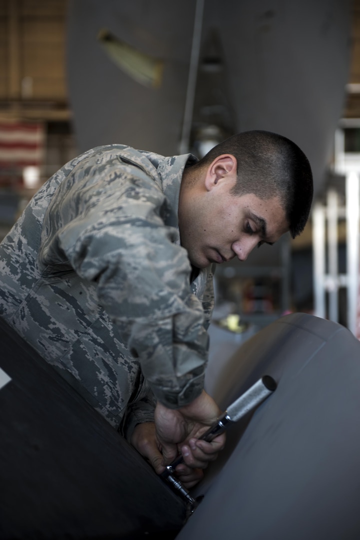 Staff Sgt. Anthony Landin, 92nd Maintenance Squadron hydraulics system craftsman, secures a ruddervator to the refueling boom Dec. 16, 2016, at Fairchild Air Force Base, Wash. A bell crank is a clamp style crank with splines that rotates the torque tube which in turn rotates the ruddervator. (U.S. Air Force photo/ Airman 1st Class Sean Campbell)