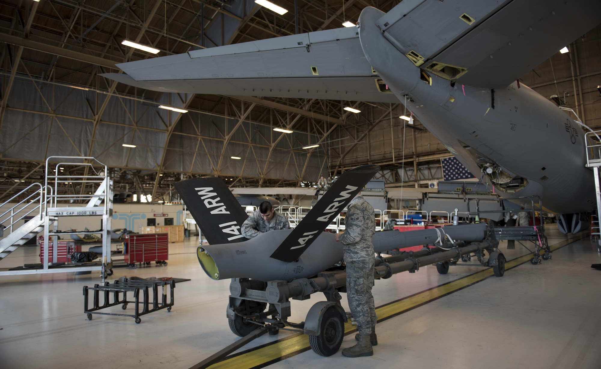 Staff Sgt. Anthony Landin, 92nd Maintenance Squadron hydraulics system craftsman, and Airman 1st Class Tage Sickler 92nd MXS hydraulics systems apprentice, install a ruddervator Dec. 16, 2016, at Fairchild Air Force Base, Wash. If any of the parts located in the ruddervator control system are installed improperly, there is the possibility of damaging the entire boom. (U.S. Air Force photo/ Airman 1st Class Sean Campbell)