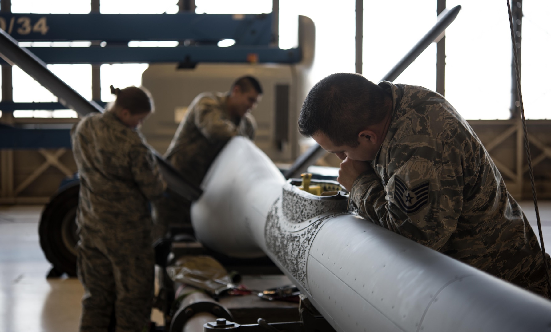 Tech. Sgt. Alfonso Vigil 92nd Maintenance Squadron hydraulics NCO in charge of dayshift, works on removing the saddle panel from the refueling boom Dec. 16, 2016, at Fairchild Air Force Base, Wash. The 92nd MXS hydraulics shop recently submitted an Air Force Technical Order correction form, correcting an issue with the KC-135 Stratotanker technical order Air Force wide. (U.S. Air Force photo/ Airman 1st Class Sean Campbell)