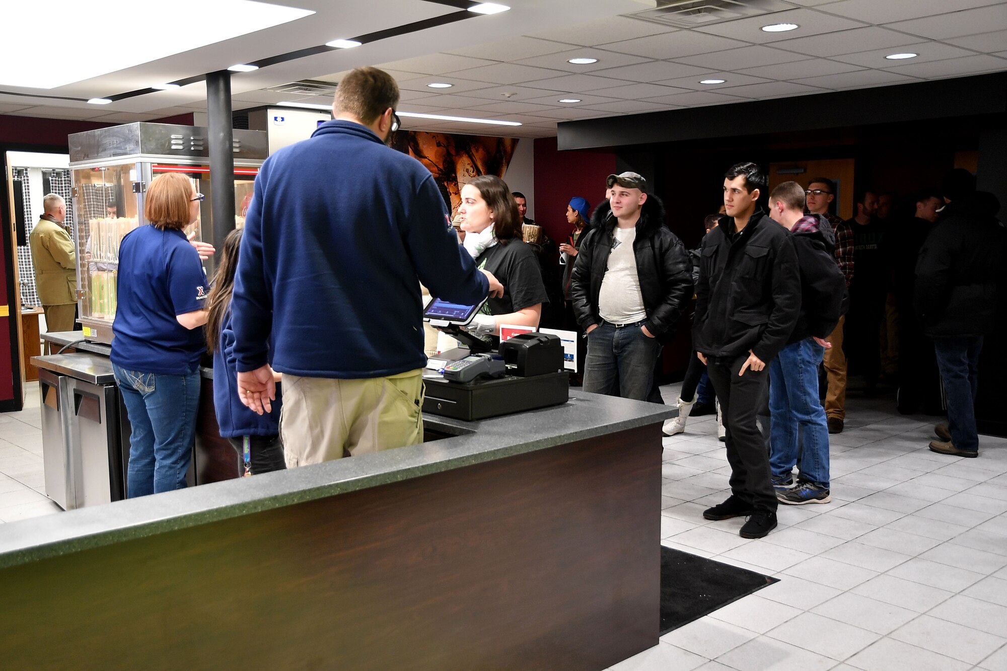 Warriors of the North wait to purchase movie tickets and concessions at the newly renovated base theater on Grand Forks Air Force Base, N.D., Dec. 16, 2016. Renovations to the theater included technological updates the point-of-sale systems, the projection system and the sound system. (U.S. Air Force photo by Airman 1st Class Elijaih Tiggs)