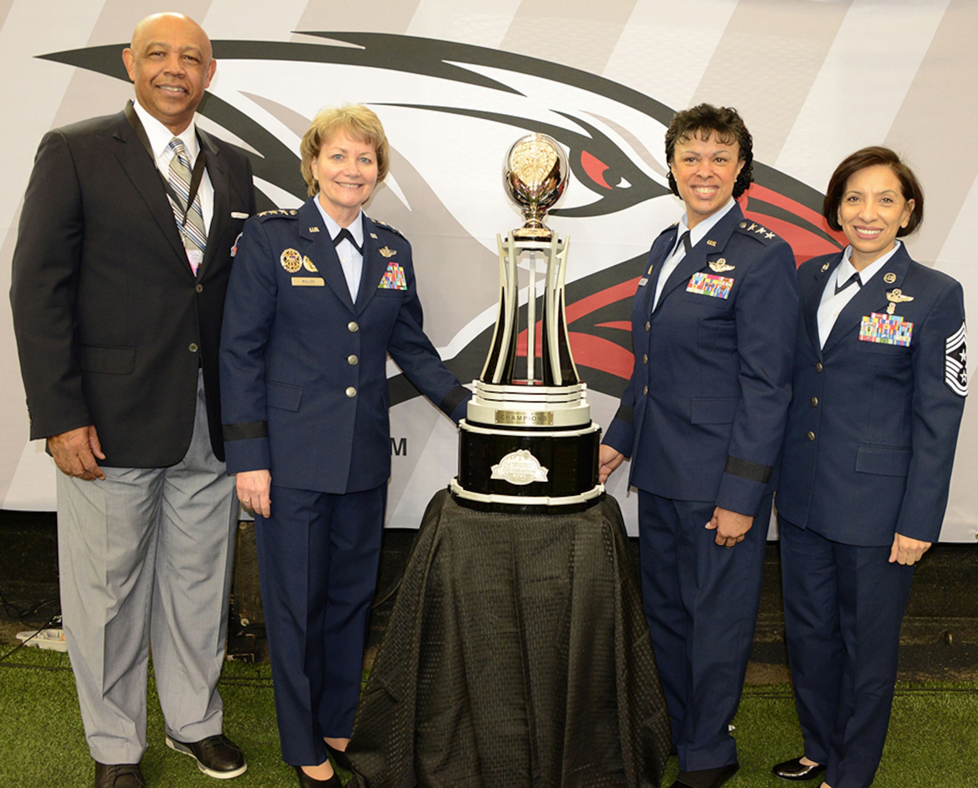 (Left to right) John T. Grant, Air Force Reserve Celebration Bowl executive director; Lt. Gen. Maryanne Miller, chief of the Air Force Reserve and commander of Air Force Reserve Command; Lt. Gen. Stayce D. Harris, assistant vice chief of staff and director, Air Staff, Headquarters U.S. Air Force, Washington D.C.; and Chief Master Sgt. Ericka Kelly, Air Force Reserve Command command chief, pose with the Air Force Reserve Celebration Bowl trophy, which was presented to the Grambling State University Tigers, who defeated the North Carolina Central University Eagles by a score of 10-9. (U.S. Air Force photo/Master Sgt. Chance Babin)