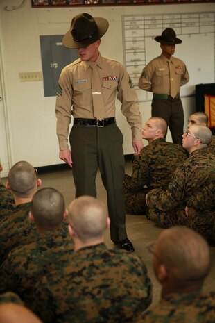 A senior drill instructor from Hotel Company, 2nd Recruit Training Battalion, explains his expectations of the recruits during pick up at Marine Corps Recruit Depot San Diego, Dec. 17. The recruits will spend their first day with their drill instructors learning the rules and regulations of recruit training, regarding everything from how to act in the squad bay to how to speak to drill instructors. Annually, more than 17,000 males recruited from the Western Recruiting Region are trained at MCRD San Diego. Hotel Company is scheduled to graduate March 10.